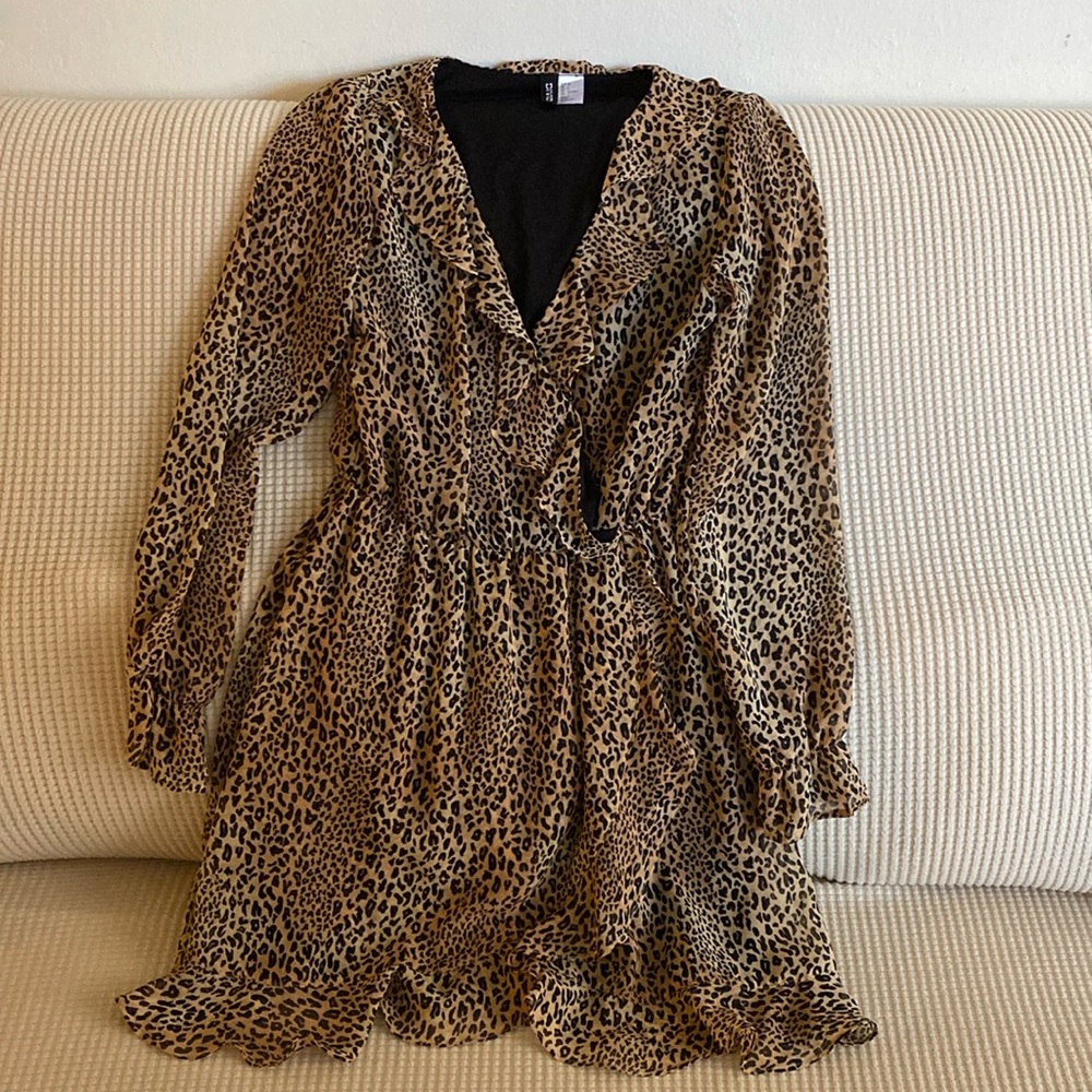 Animal print mini dress with ruffles along the neck sleeves and hem